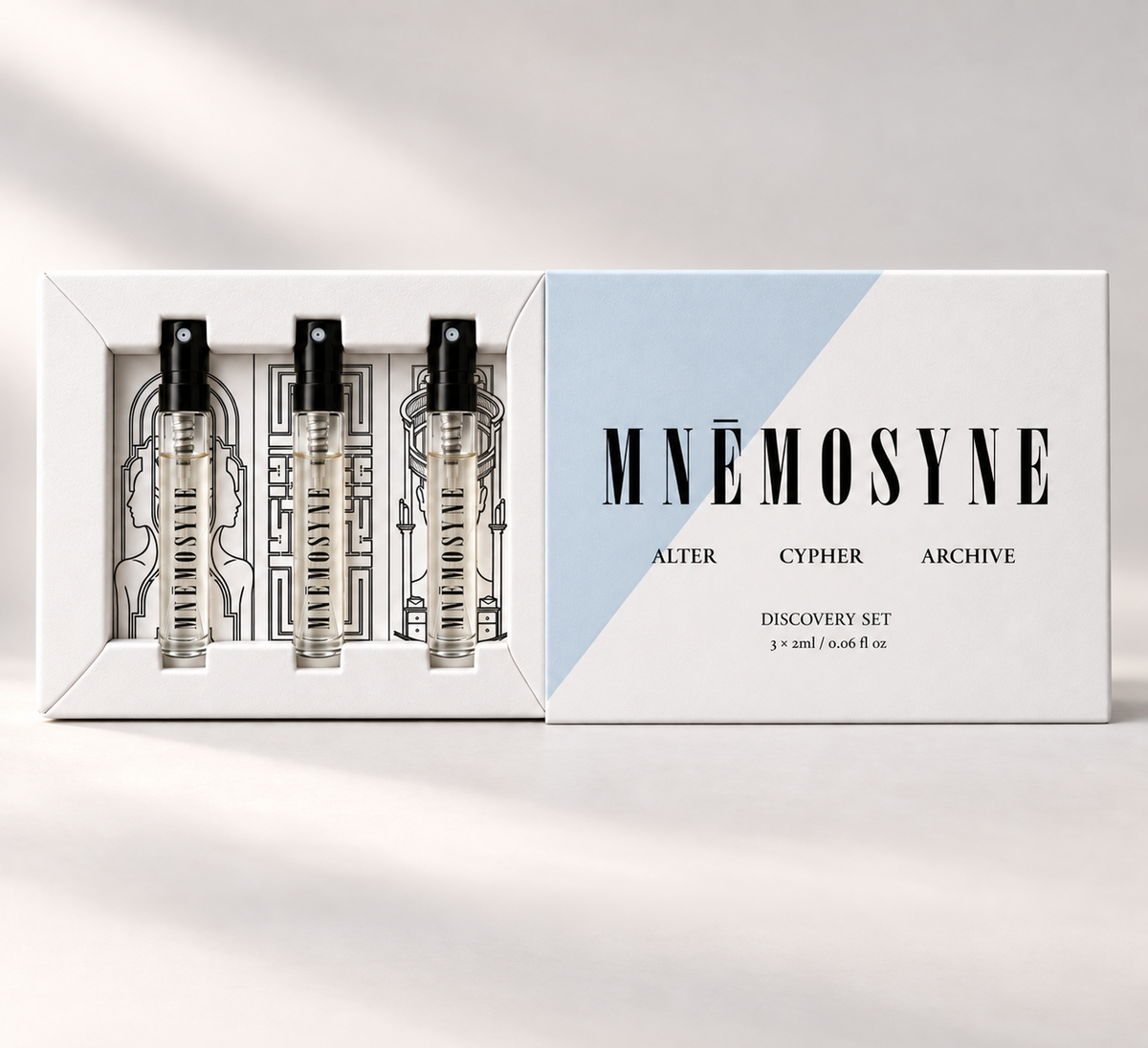 MNĒMOSYNE Identity Trilogy Discovery Set open beside its sleeve, with three 2 mL perfume sprays